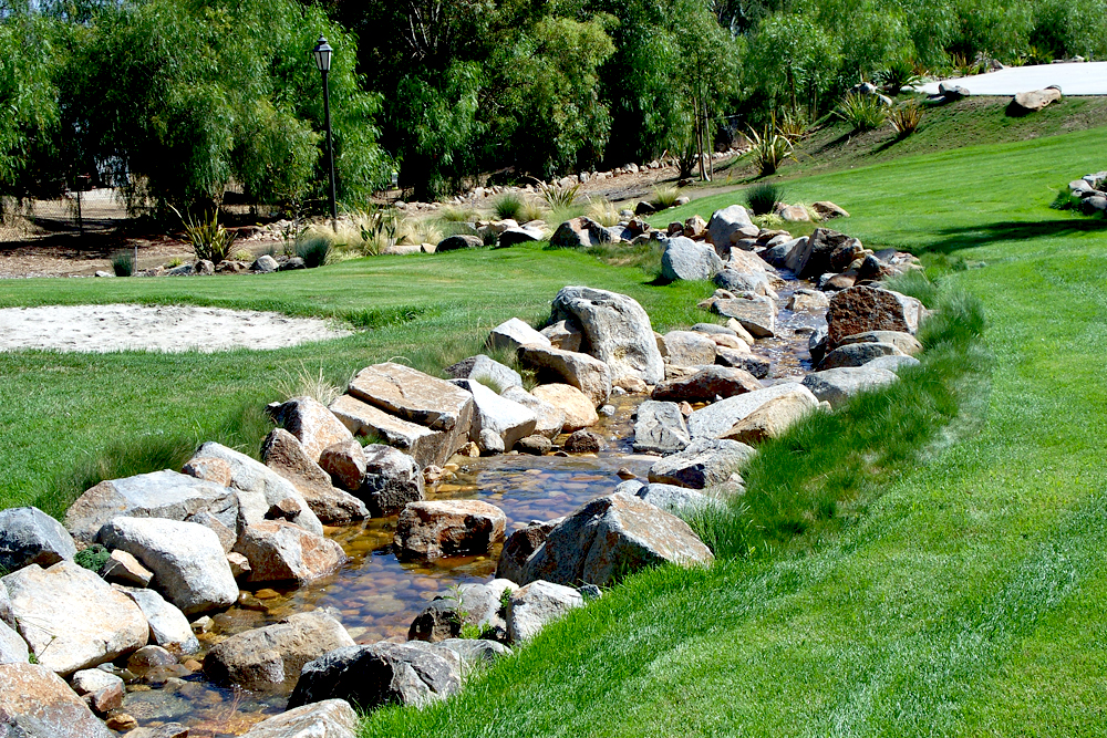 course fountain, rock stream and trees and borders